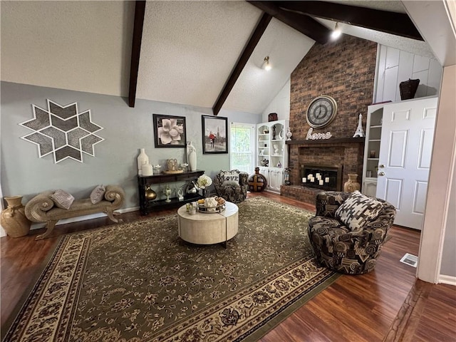 4024 NE 59th Ter, Gladstone, MO 64119 - living area with visible vents, lofted ceiling with beams, a brick fireplace, and wood finished floors