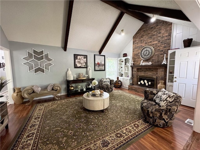 4024 NE 59th Ter, Gladstone, MO 64119 - living area featuring visible vents, a brick fireplace, wood finished floors, a textured ceiling, and lofted ceiling with beams