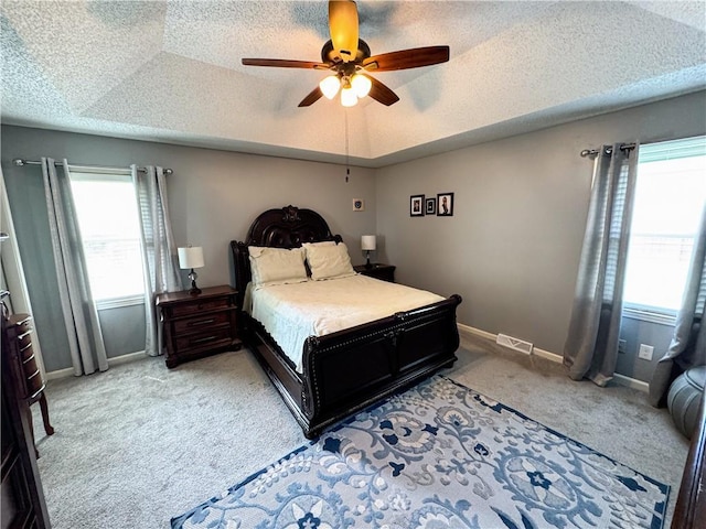 4024 NE 59th Ter, Gladstone, MO 64119 - bedroom with light carpet, a textured ceiling, a ceiling fan, baseboards, and visible vents
