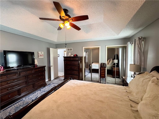 4024 NE 59th Ter, Gladstone, MO 64119 - carpeted bedroom featuring visible vents, multiple closets, baseboards, ceiling fan, and a textured ceiling