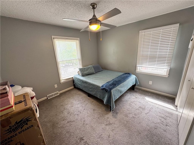 4024 NE 59th Ter, Gladstone, MO 64119 - bedroom featuring baseboards, carpet floors, a textured ceiling, and visible vents