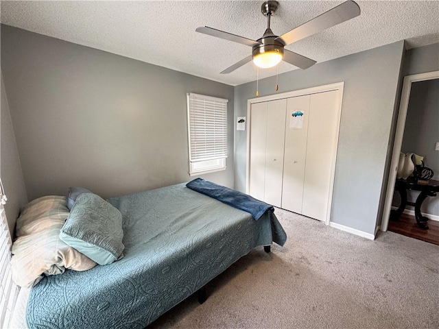 4024 NE 59th Ter, Gladstone, MO 64119 - bedroom with ceiling fan, a textured ceiling, baseboards, a closet, and carpet flooring