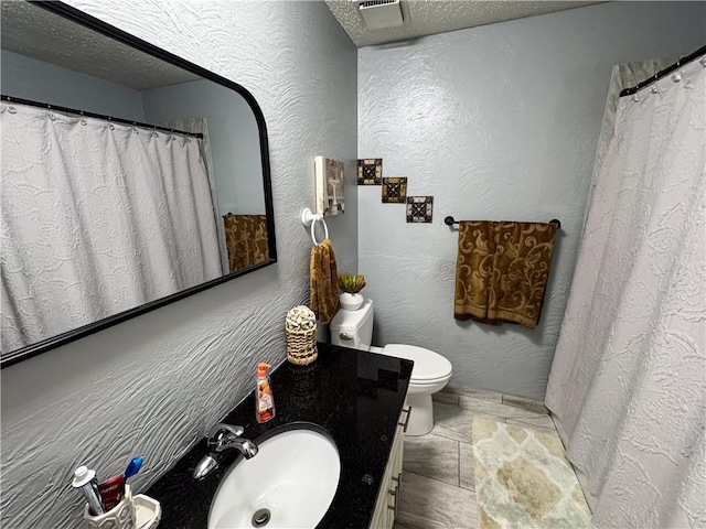 4024 NE 59th Ter, Gladstone, MO 64119 - bathroom with toilet, a textured ceiling, visible vents, and vanity