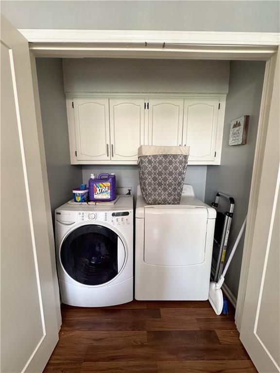 4024 NE 59th Ter, Gladstone, MO 64119 - laundry room with baseboards, independent washer and dryer, cabinet space, and dark wood-style floors