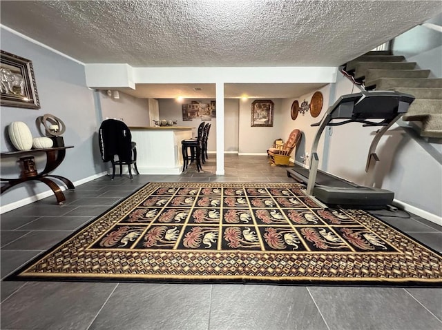4024 NE 59th Ter, Gladstone, MO 64119 - workout room featuring a textured ceiling and baseboards