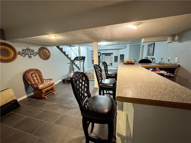 4024 NE 59th Ter, Gladstone, MO 64119 - bar featuring baseboards, a textured ceiling, stairway, and dark tile patterned flooring