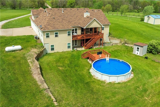 back of property featuring a storage unit, a wooden deck, and an outdoor structure
