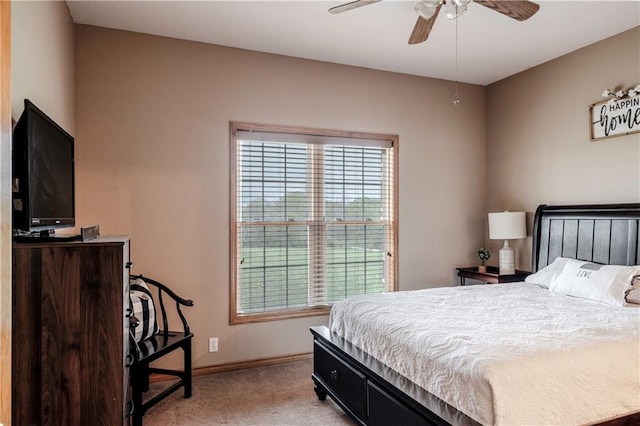 bedroom with baseboards, ceiling fan, and light carpet