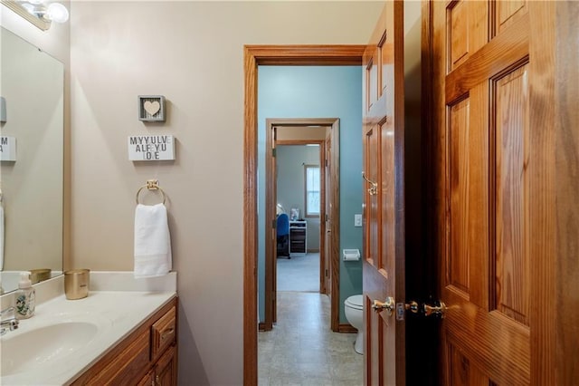 bathroom featuring toilet, tile patterned floors, and vanity