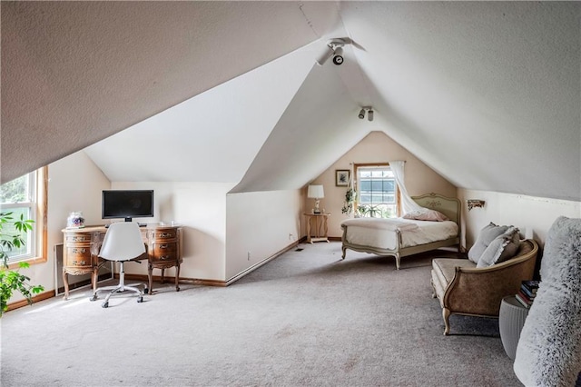 carpeted bedroom with baseboards, vaulted ceiling, and a textured ceiling