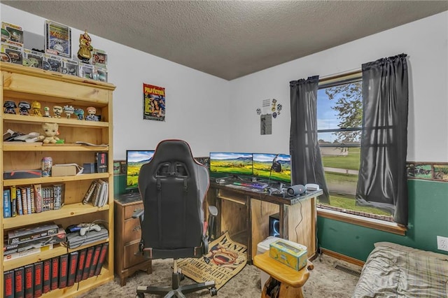 recreation room featuring carpet flooring, a textured ceiling, and visible vents