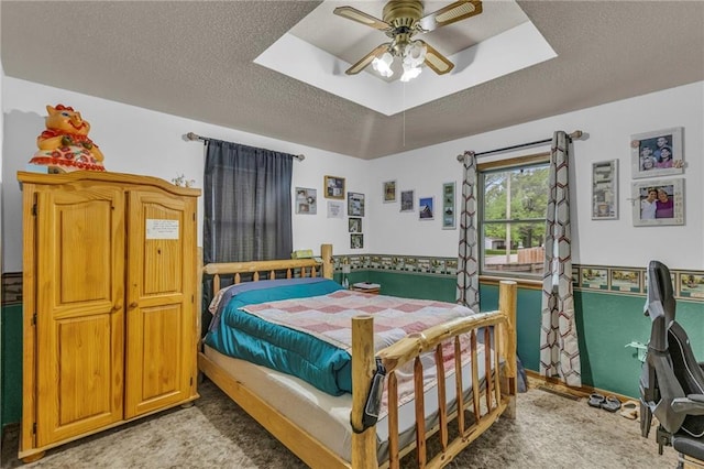bedroom with a ceiling fan and a textured ceiling