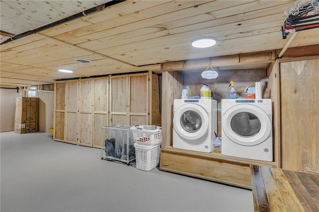 laundry area featuring wooden ceiling, laundry area, and washing machine and dryer