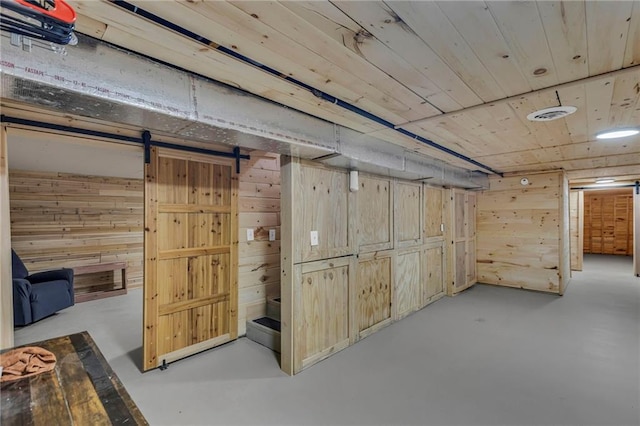 finished below grade area featuring wooden walls and wooden ceiling