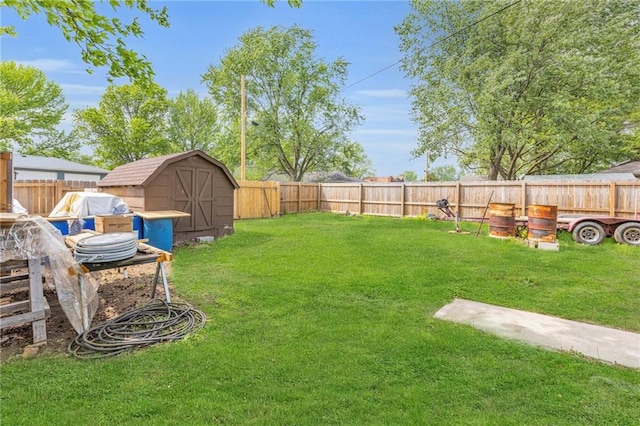 view of yard with a fenced backyard, an outbuilding, and a storage shed