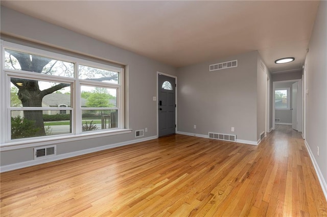 foyer with light wood-style floors and visible vents
