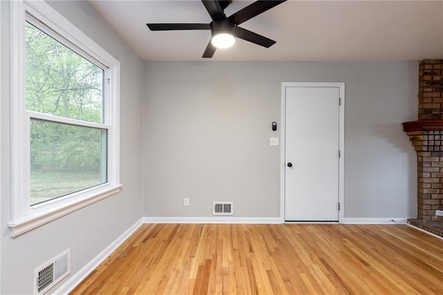 unfurnished room featuring visible vents, light wood-style floors, ceiling fan, and baseboards