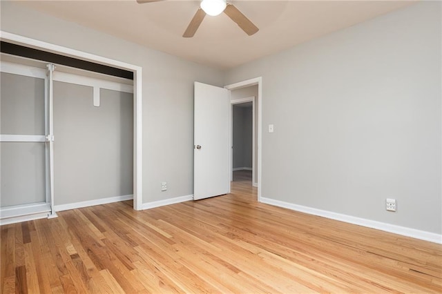 unfurnished bedroom with light wood-style floors, baseboards, ceiling fan, and a closet