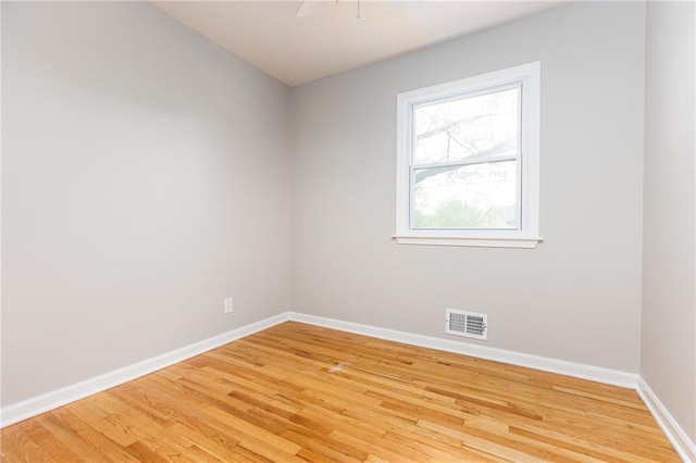 unfurnished room with baseboards, visible vents, and light wood-style flooring