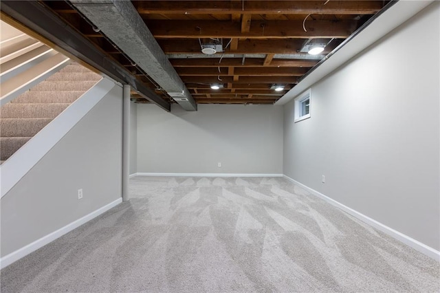 below grade area featuring carpet floors and baseboards