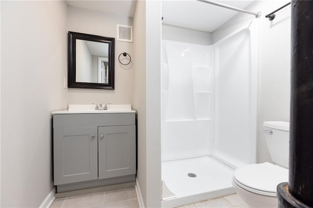 bathroom with visible vents, a stall shower, vanity, baseboards, and toilet