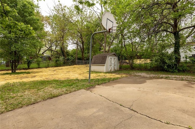 exterior space featuring a storage unit, an outdoor structure, and fence