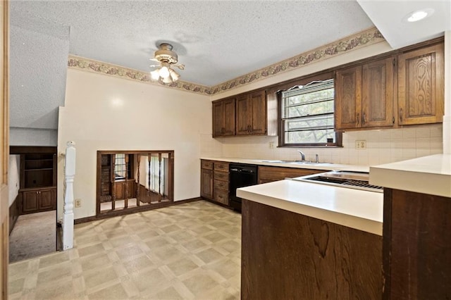 kitchen featuring a ceiling fan, light floors, black dishwasher, light countertops, and a sink
