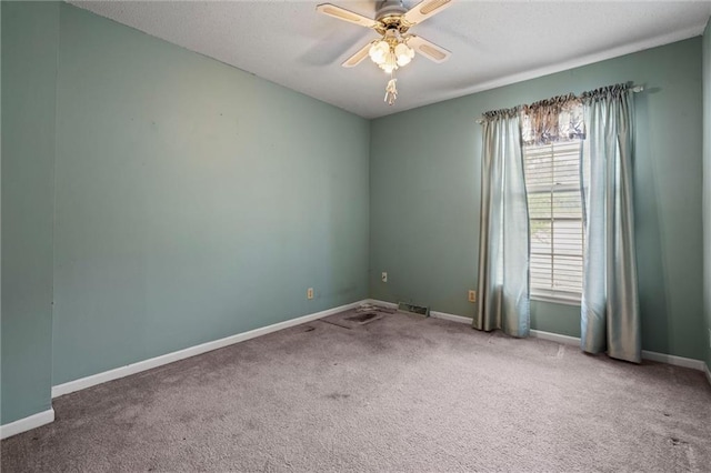 unfurnished room with baseboards, ceiling fan, carpet flooring, and a textured ceiling