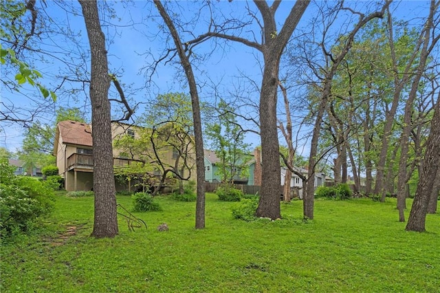 view of yard with a residential view and a wooden deck
