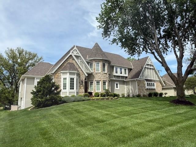 view of front of house with a front yard and stone siding