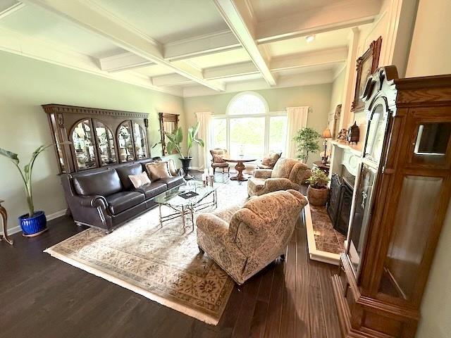 living room featuring a fireplace with raised hearth, coffered ceiling, beam ceiling, and dark wood-style floors