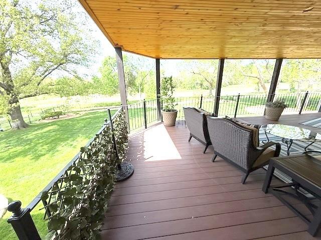 wooden deck featuring a yard