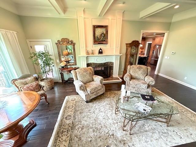 living area with beamed ceiling, dark wood finished floors, and a wealth of natural light