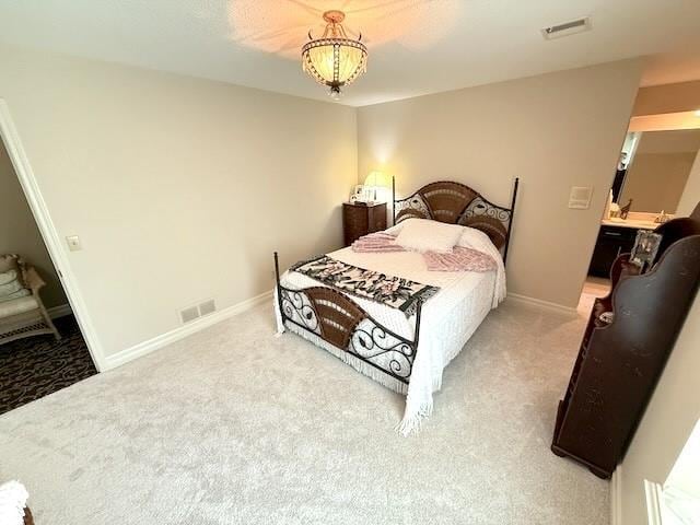 carpeted bedroom featuring baseboards and visible vents