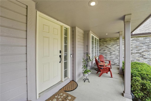 22721 E 27th Street Ct S, Blue Springs, MO 64015 - doorway to property featuring a porch and brick siding