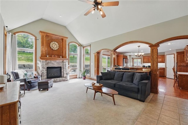 22721 E 27th Street Ct S, Blue Springs, MO 64015 - living room featuring arched walkways, ornate columns, healthy amount of natural light, lofted ceiling, and recessed lighting