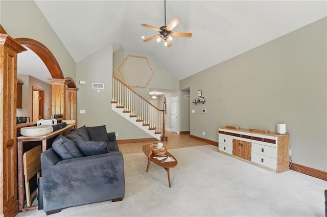 22721 E 27th Street Ct S, Blue Springs, MO 64015 - living room with ceiling fan, stairway, high vaulted ceiling, light colored carpet, and arched walkways