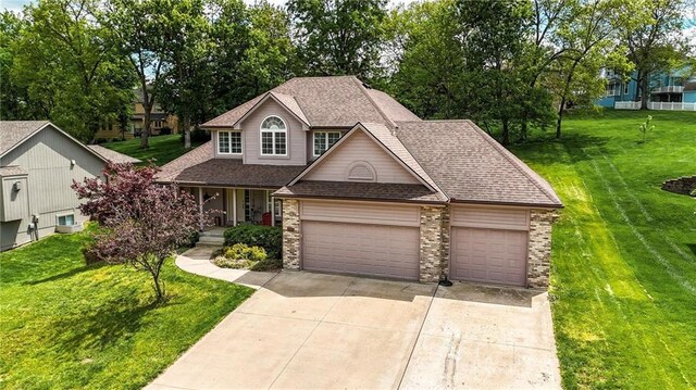 22721 E 27th Street Ct S, Blue Springs, MO 64015 - traditional-style home with a garage, driveway, a front lawn, a shingled roof, and a porch