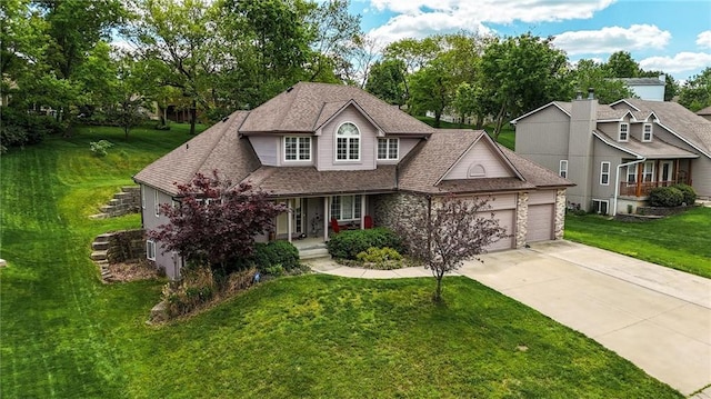 22721 E 27th Street Ct S, Blue Springs, MO 64015 - traditional-style house with a garage, covered porch, driveway, a front yard, and roof with shingles