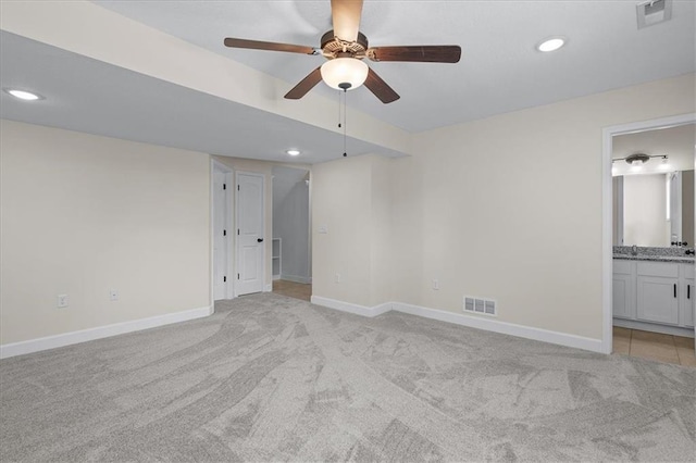 unfurnished bedroom featuring visible vents, baseboards, and light carpet