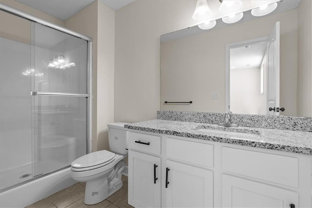 full bathroom featuring vanity, toilet, tile patterned flooring, and a stall shower