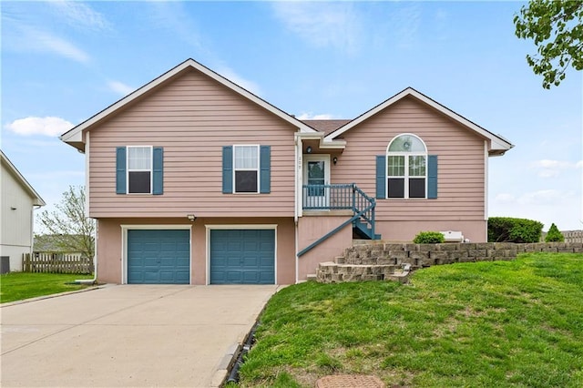 single story home featuring a garage, driveway, and a front yard