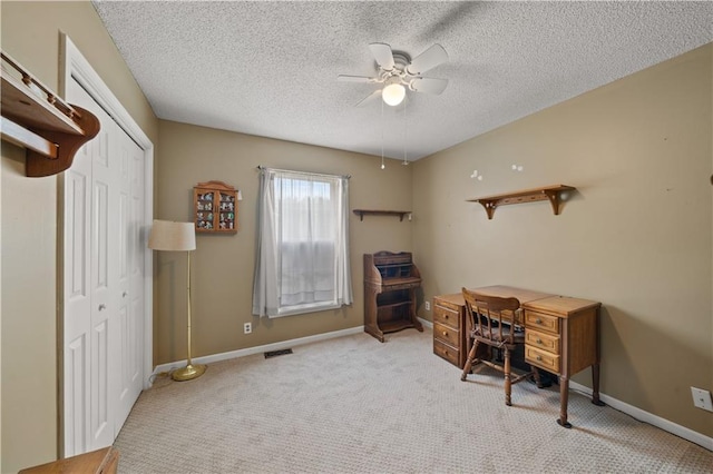 office area with carpet floors, baseboards, ceiling fan, and visible vents