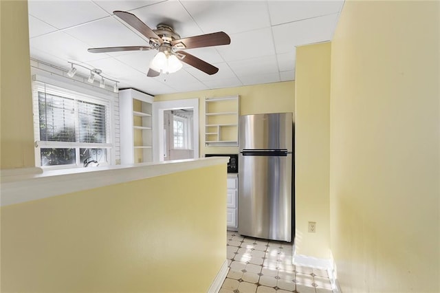 3700 Jefferson St, Kansas City, MO 64111 - kitchen featuring freestanding refrigerator, baseboards, ceiling fan, and built in shelves