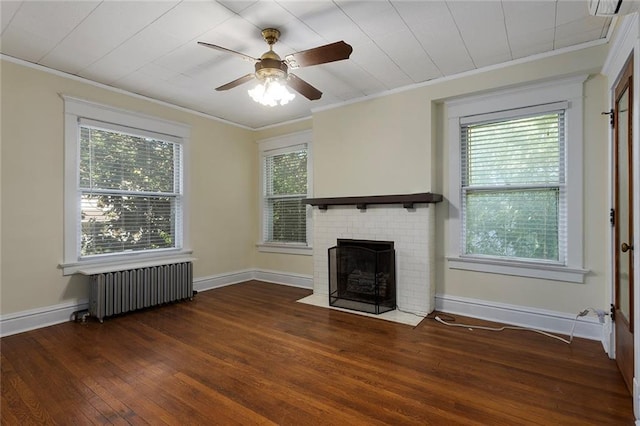 3700 Jefferson St, Kansas City, MO 64111 - unfurnished living room featuring radiator, crown molding, hardwood / wood-style flooring, a fireplace, and a ceiling fan