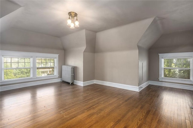 3700 Jefferson St, Kansas City, MO 64111 - additional living space featuring radiator, lofted ceiling, hardwood / wood-style flooring, plenty of natural light, and baseboards