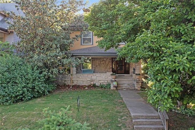 3700 Jefferson St, Kansas City, MO 64111 - obstructed view of property with covered porch, a front lawn, and stone siding