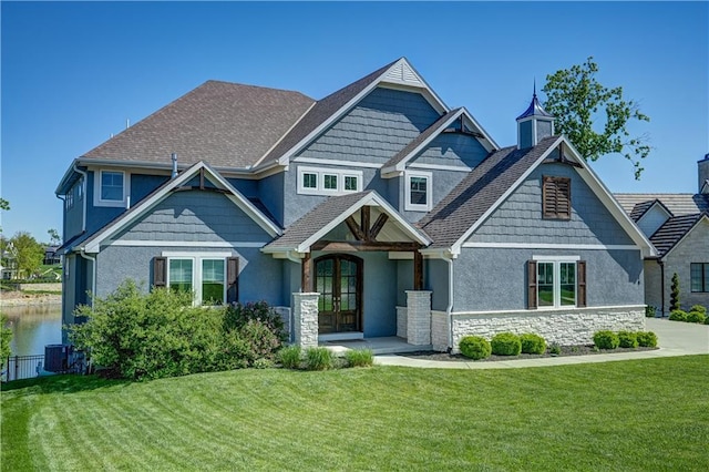 18 Black Hawk Dr, Lake Winnebago, MO 64034 - craftsman-style home featuring french doors, a front lawn, stone siding, stucco siding, and central AC unit