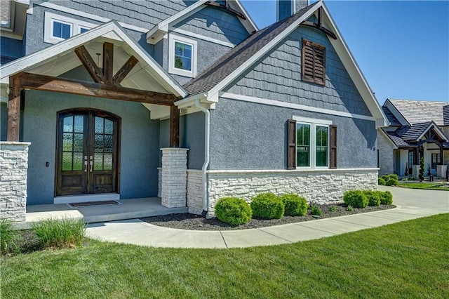 18 Black Hawk Dr, Lake Winnebago, MO 64034 - entrance to property featuring stone siding, french doors, a yard, and stucco siding