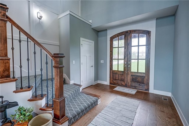 18 Black Hawk Dr, Lake Winnebago, MO 64034 - foyer featuring french doors, stairway, wood finished floors, baseboards, and a towering ceiling